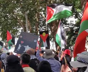Pro-Palestine rally in Sydney with Palestinian and Indigenous Australian flags flying